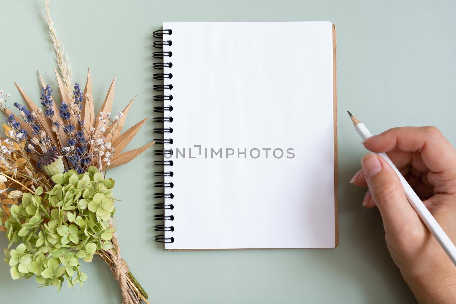 Blank sheet paper notebook on colored background top view. Flat lay.