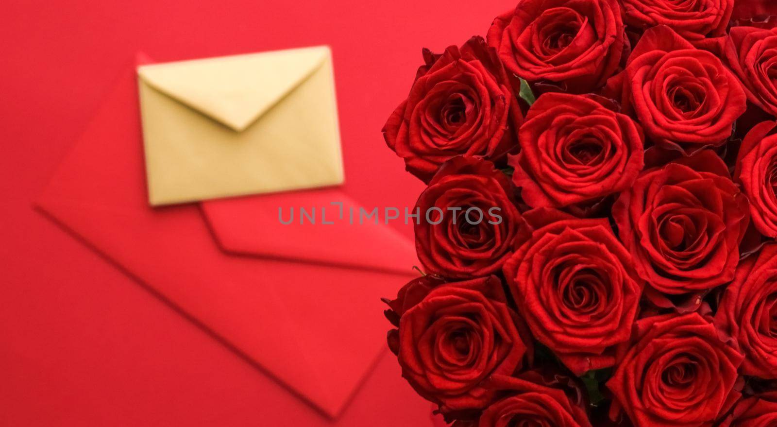 Holiday gift, flowers flatlay and happy relationship concept - Love letter and flower delivery service on Valentines Day, luxury bouquet of red roses and card envelopes on red background