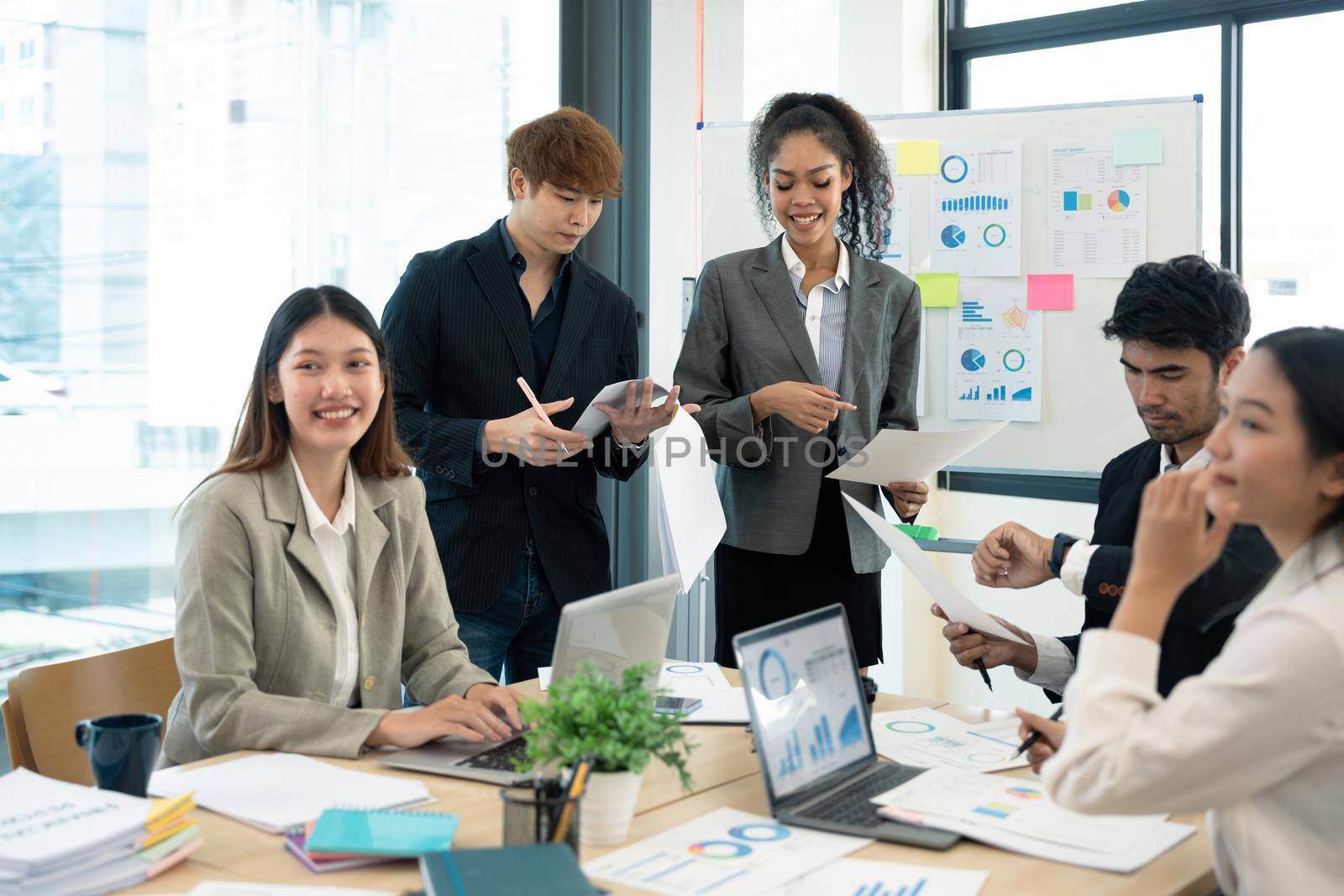 Group of young businessman talking with young and mature colleagues in boardroom at meeting. brainstorming, discussing analyzing business strategy concept