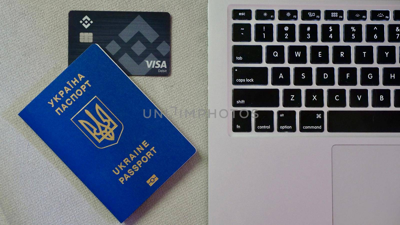 Laptop, Ukrainian passport, card binance to buy bitcoin crypto exchange for support Ukraine during the market crash, war . Trading, spot, staking. Workspace freelance flatlay