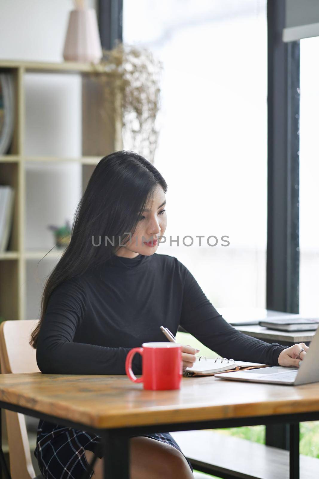 Attractive creative woman working in modern workplace.