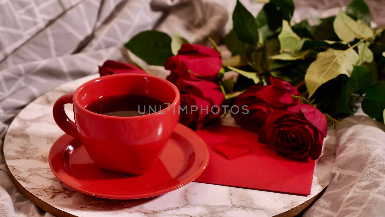 Background Festive Flatlay, composition for Valentine's Day on February 14. Coffee in a red cup, red rose flowers and special letter