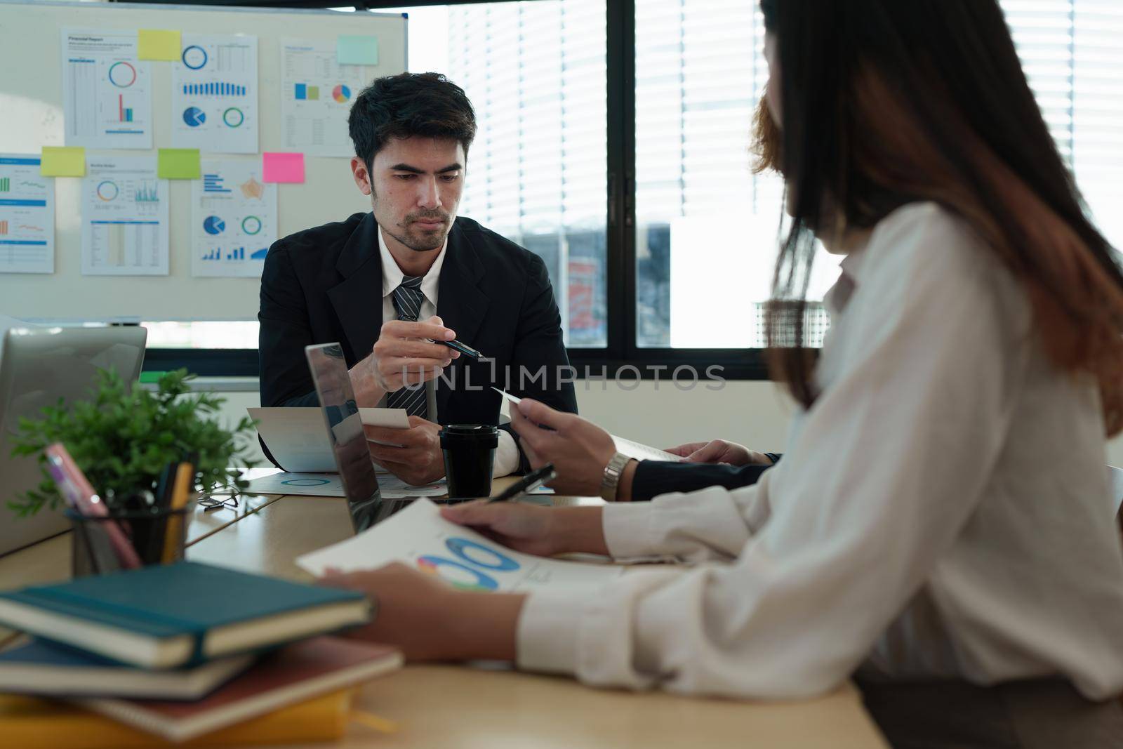 Analytics intelligence concept. Group of business people discuss current financial and economic on laptop for investment at the meeting.