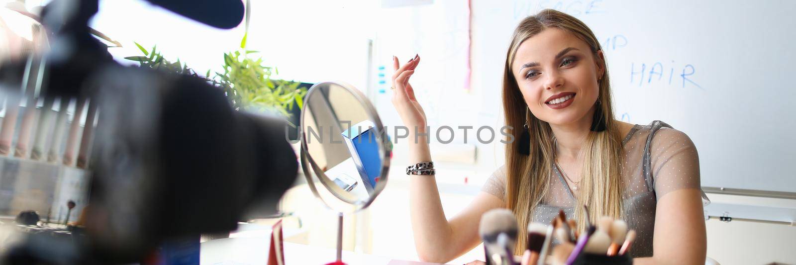 Woman blogger conducts makeup training remotely. Online courses in skin care concept