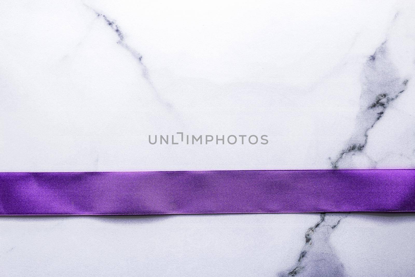 Happy holidays, festive decoration and brand sale promotion concept - Purple silk ribbon and bow on luxury marble background, holiday flatlay backdrop