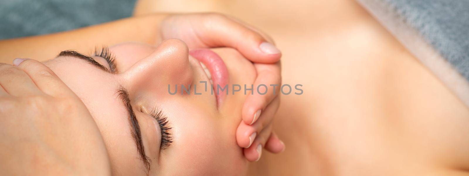 Face massage of detox therapy for the pretty female patient at spa salon