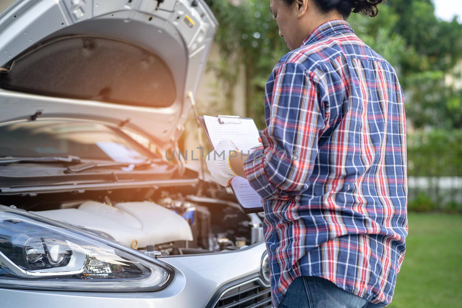 Open hood mechanic engine system to check and repair damage car crash.