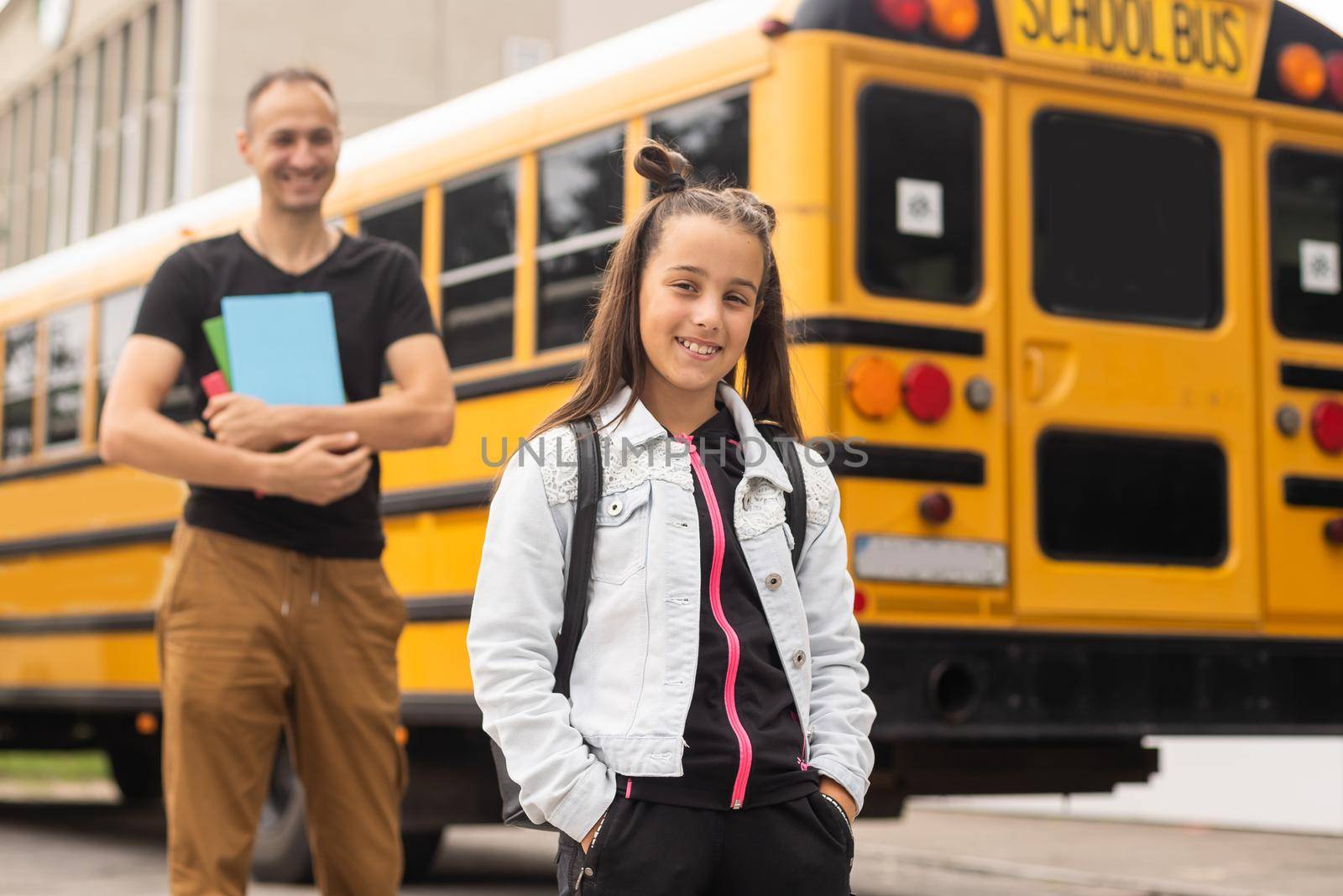 Parent taking child to school. Pupil of primary school go study with backpack outdoors. Father and son go hand in hand. Beginning of lessons. Back to school. First day of fall. Elementary student.