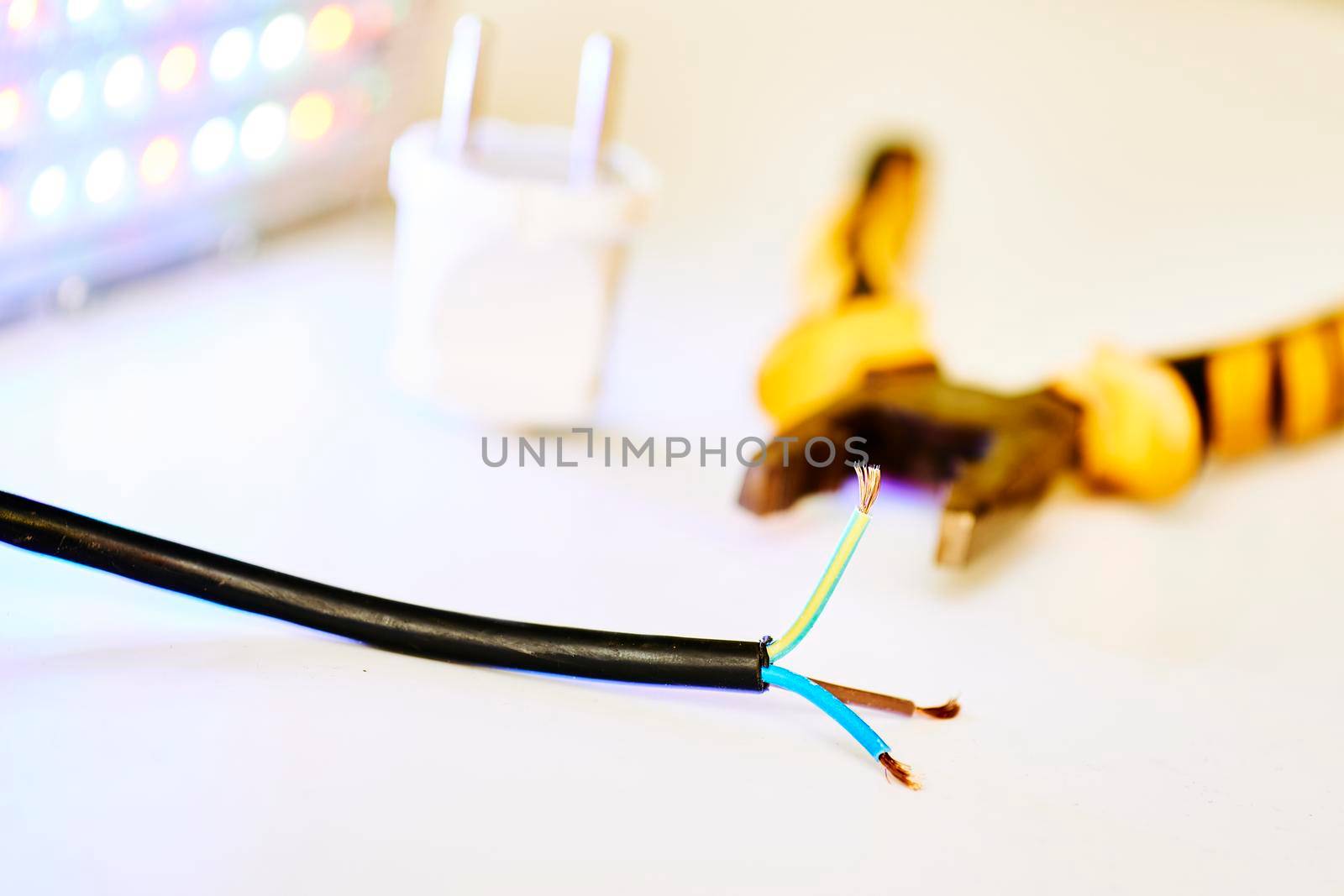 Electrical equipment for connection.Three-core electric cable, metalwork pliers and LED lamp