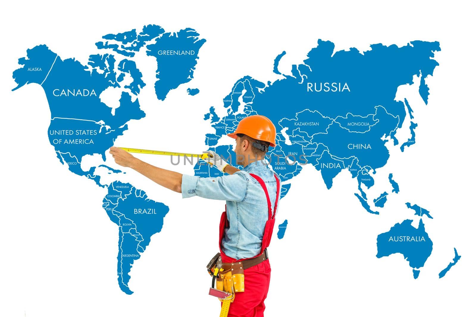 Worker in hard hat measure with ruler world map background.