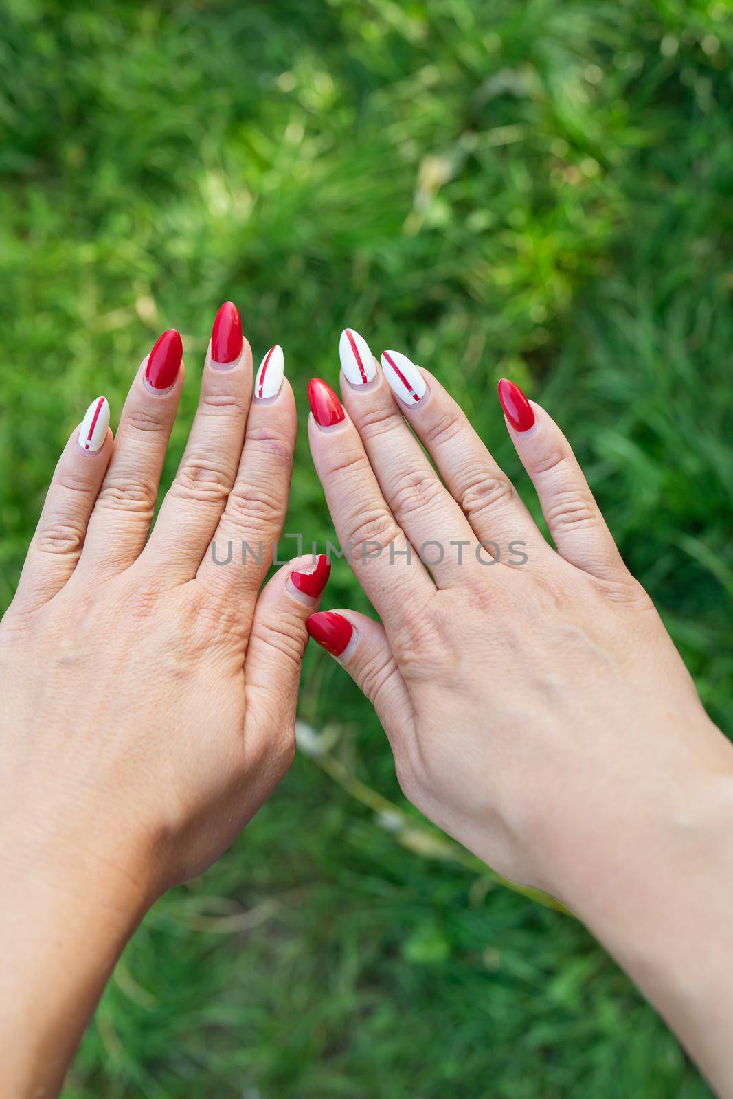 The girl shows a bad old manicure. Overgrown nail polish, broken nail. Manicure correction, old manicure. Nail care, it's time to go to the salon