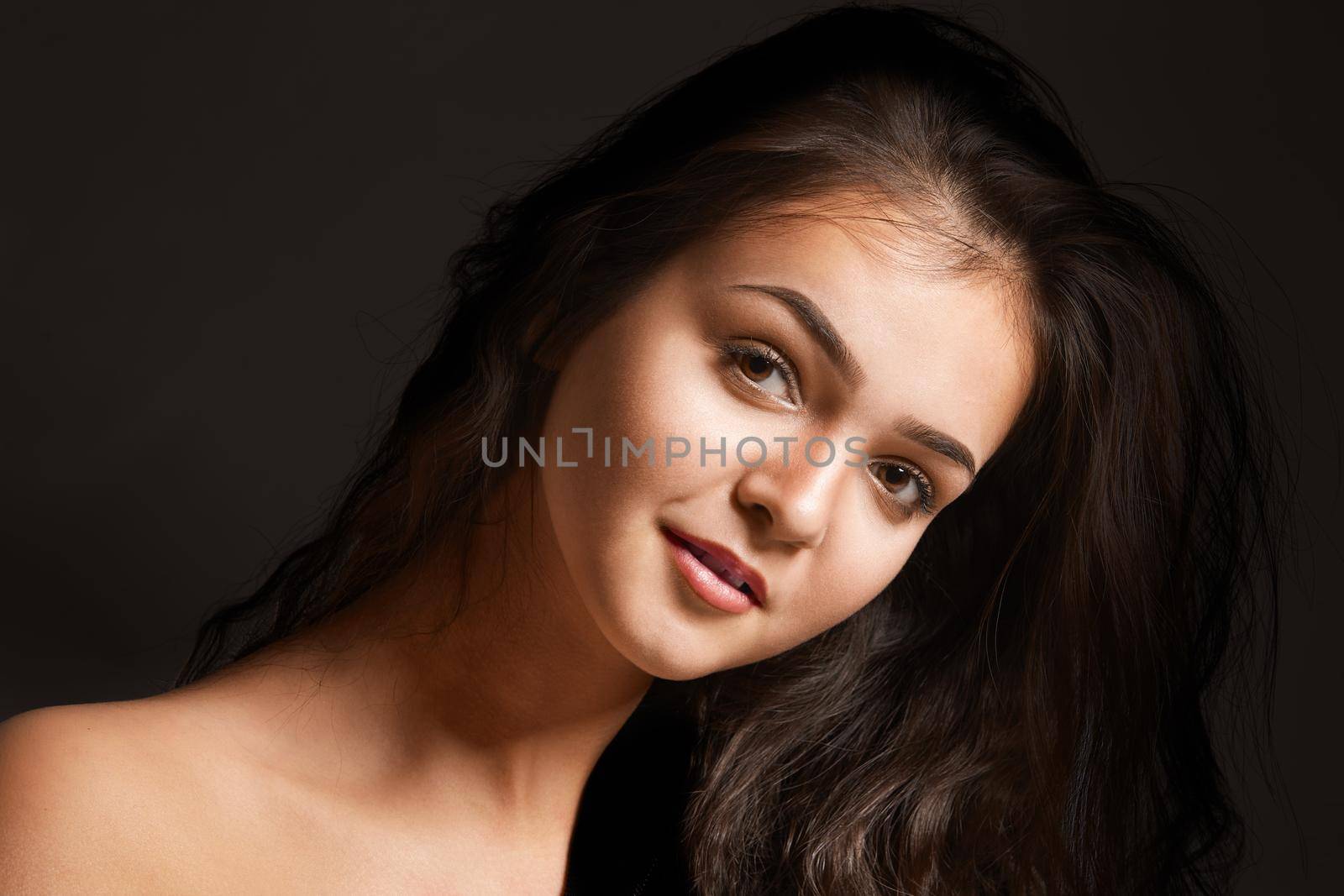 fashionable young woman in studio on dark background