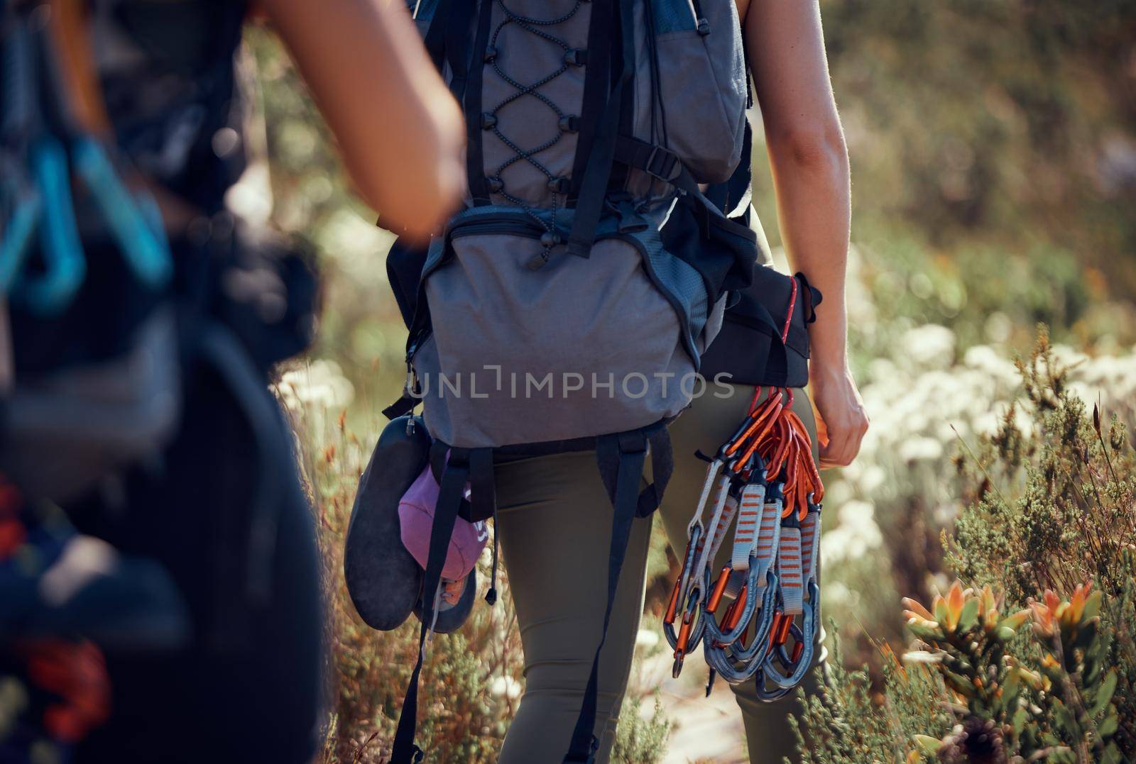 Rock climbing, fitness women and safety harness and equipment while hiking, travel and adventure for outdoor nature workout, travel and adventure. Active, sports and exercise while or mountaineering.