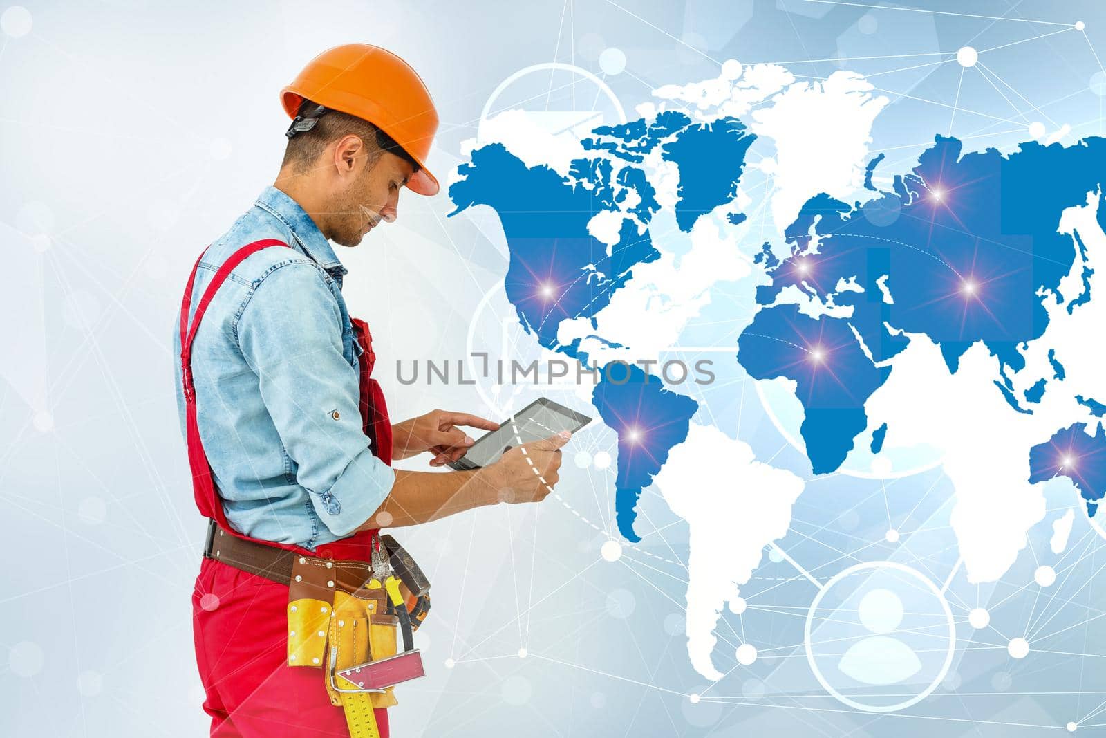 Side view man engineer wearing protective helmet using a tablet computer gadget choosing destinations on the world map. Modern technology artificial intelligence concept