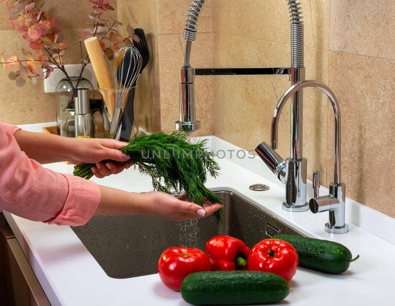 Girl washes herbs and vegetables for salad by sdf_qwe
