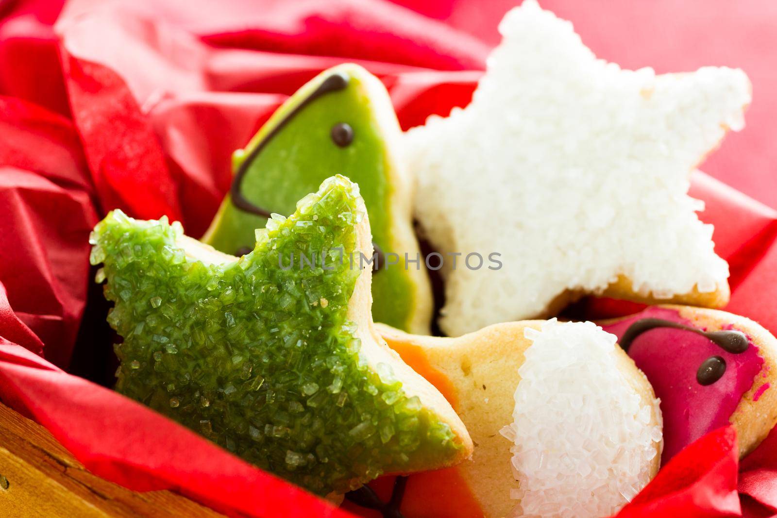 Assorted christmas cookies on red background.