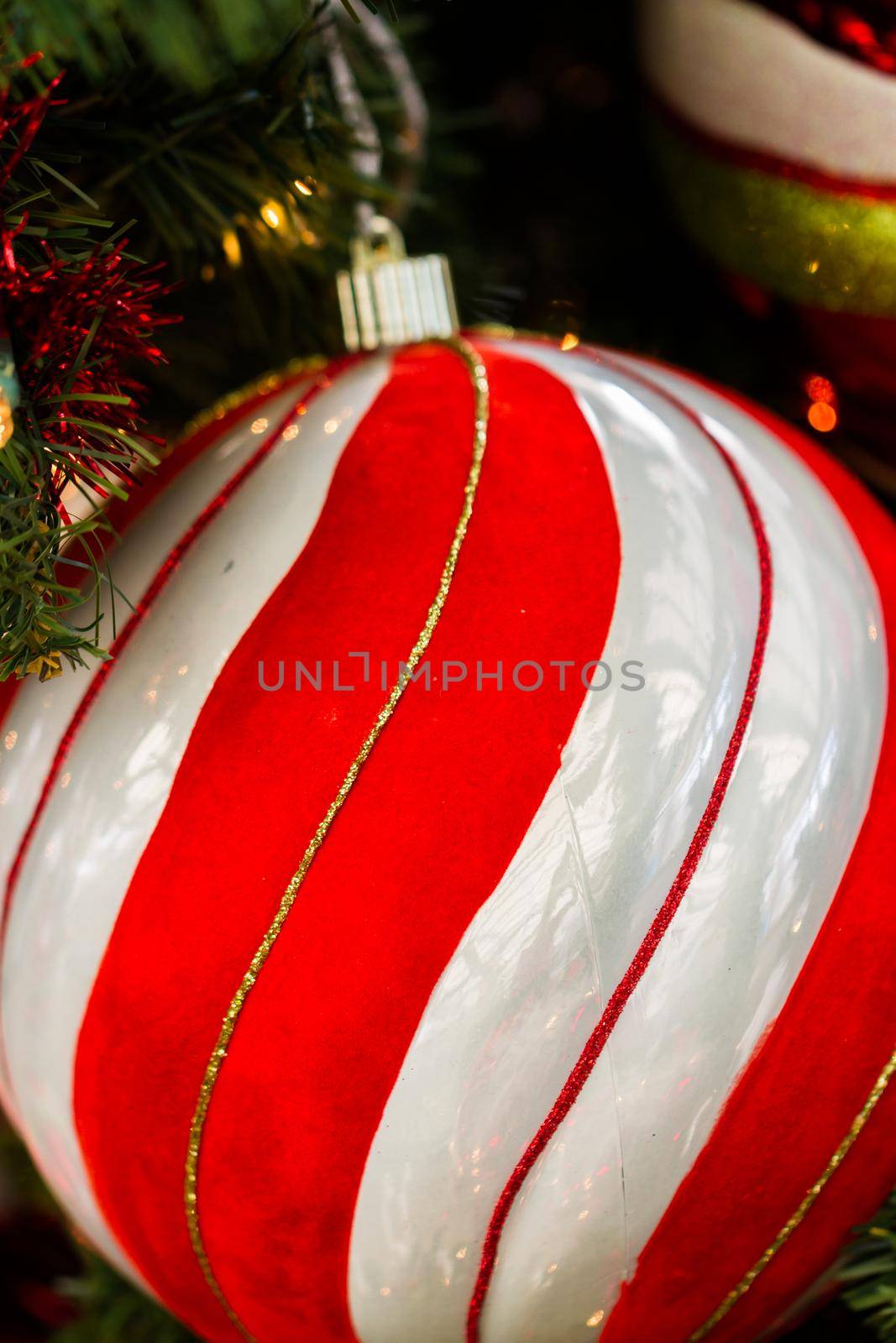 Candy cane ball christmas ornament on the tree.