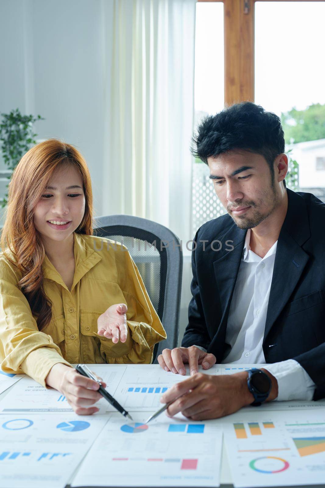 Portrait of a female business owner and partner company meeting to collaborate to invest in imported goods, plan to increase marketing profits using budget documents and working calculator by Manastrong