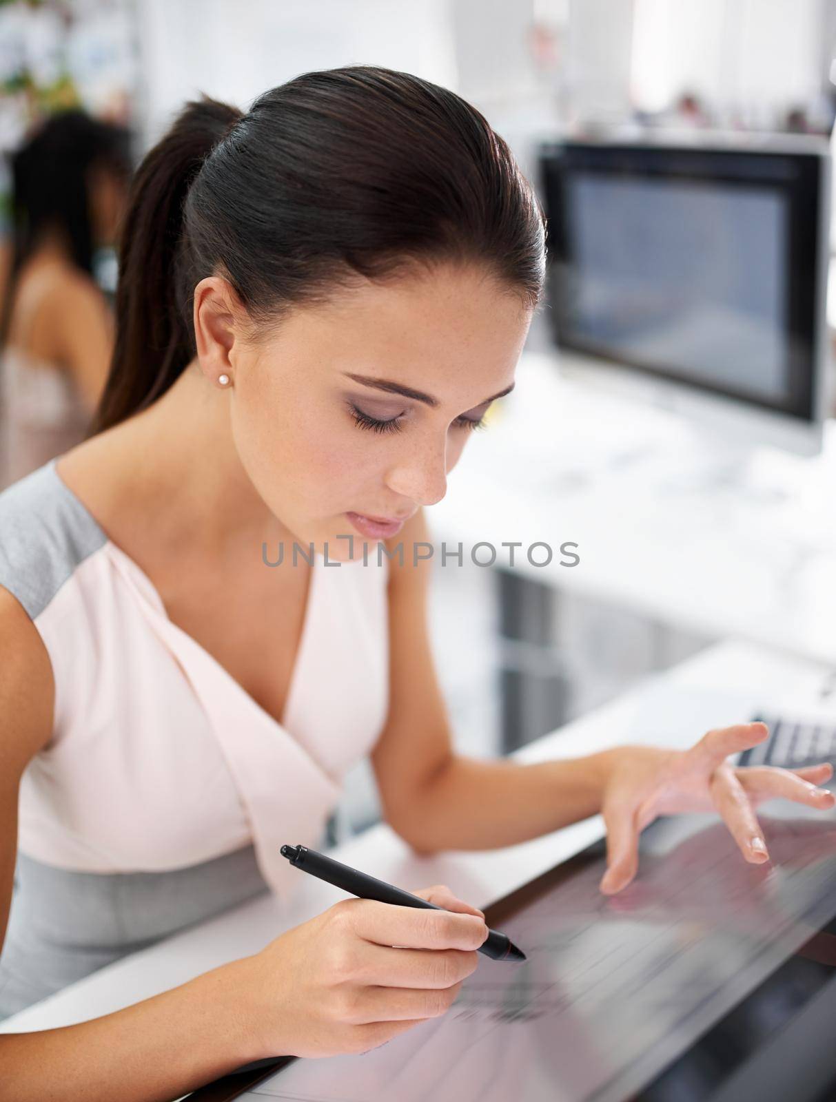 The latest technology is on her side. A young woman working on a digital touchscreen