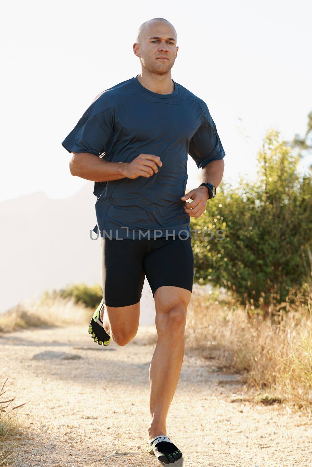 Pumped up for fitness. a young runner training outdoors