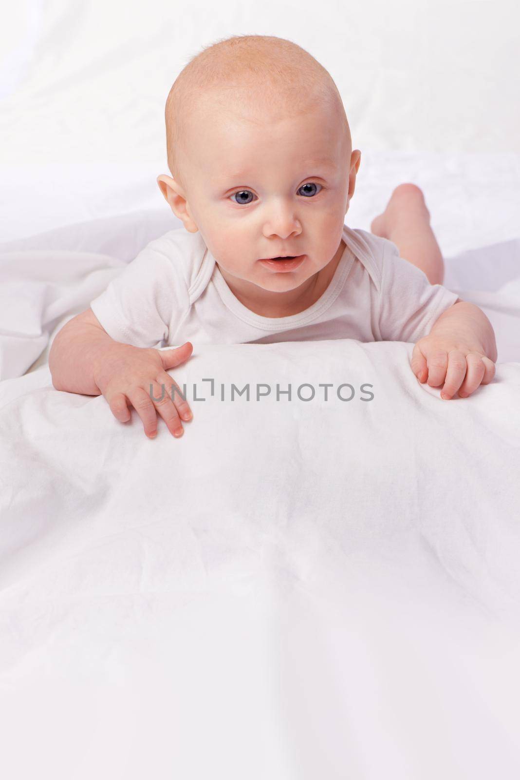 The world holds many wonders ahead for him. an adorable baby boy in a studio. by YuriArcurs