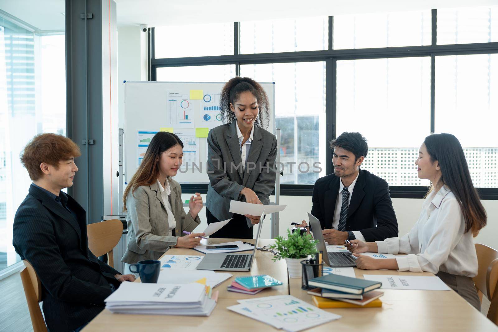 Diverse business people meeting new startup project pointing graph discussion and analysis data charts and graphs.Business finances and accounting concept.