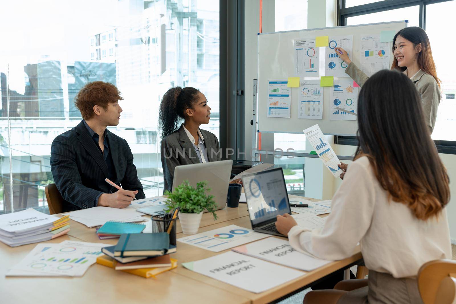 Diverse business people meeting new startup project pointing graph discussion and analysis data charts and graphs.Business finances and accounting concept.