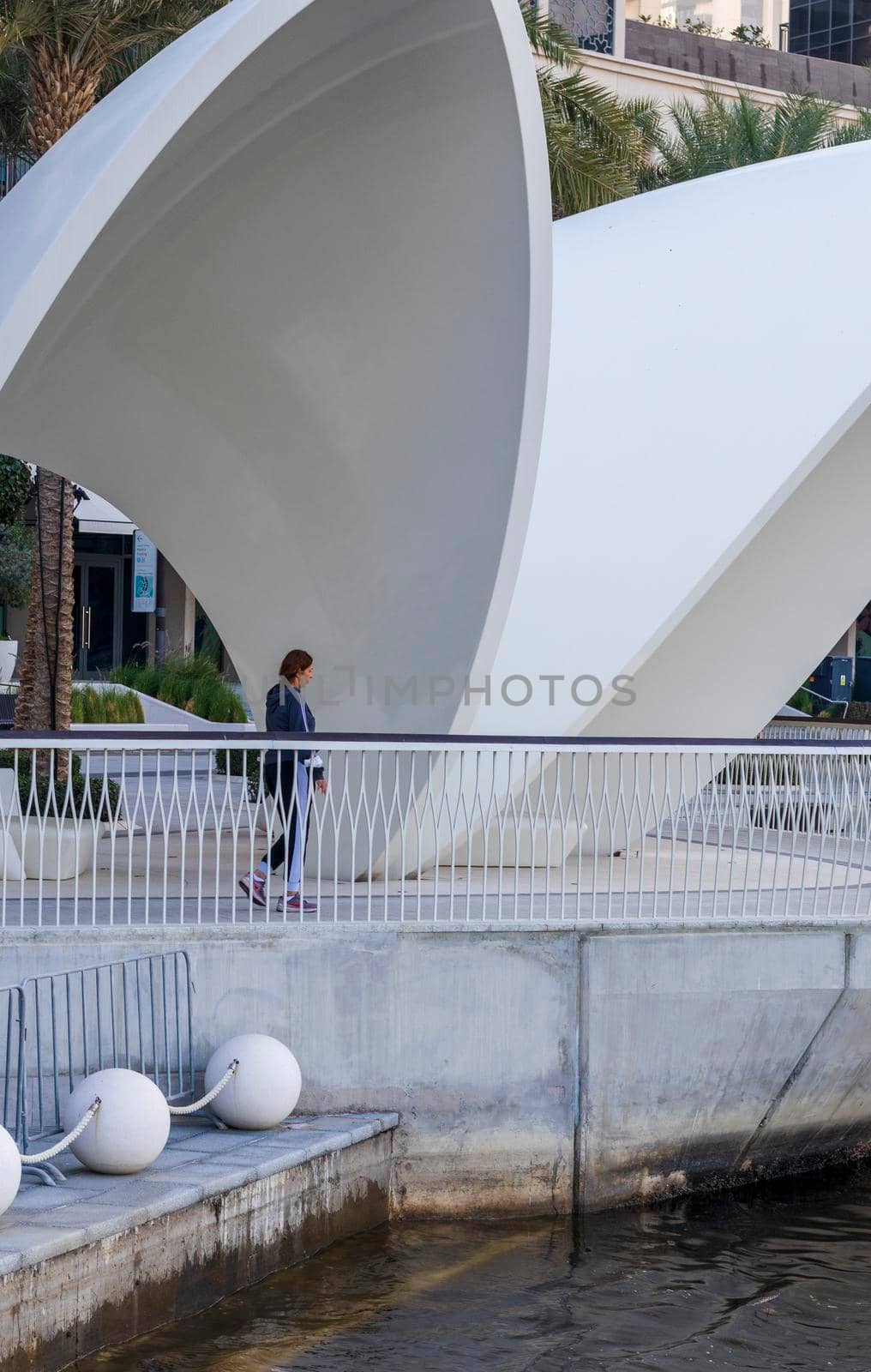 Dubai, UAE - 02.11.2022 - Woman walking in the morning at Dubai creek harbour area