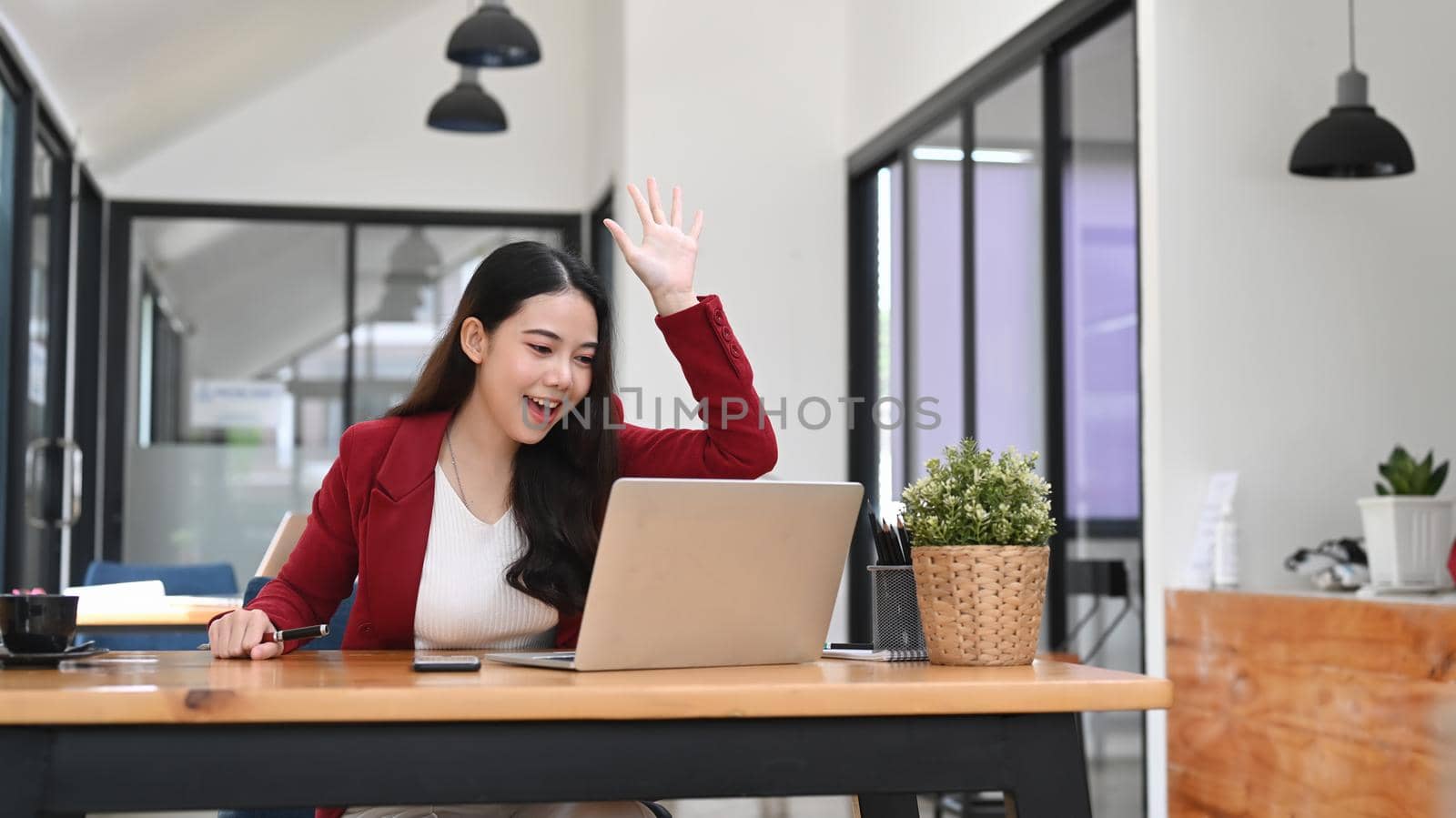 Young asian businesswoman having video conference with laptop computer.
