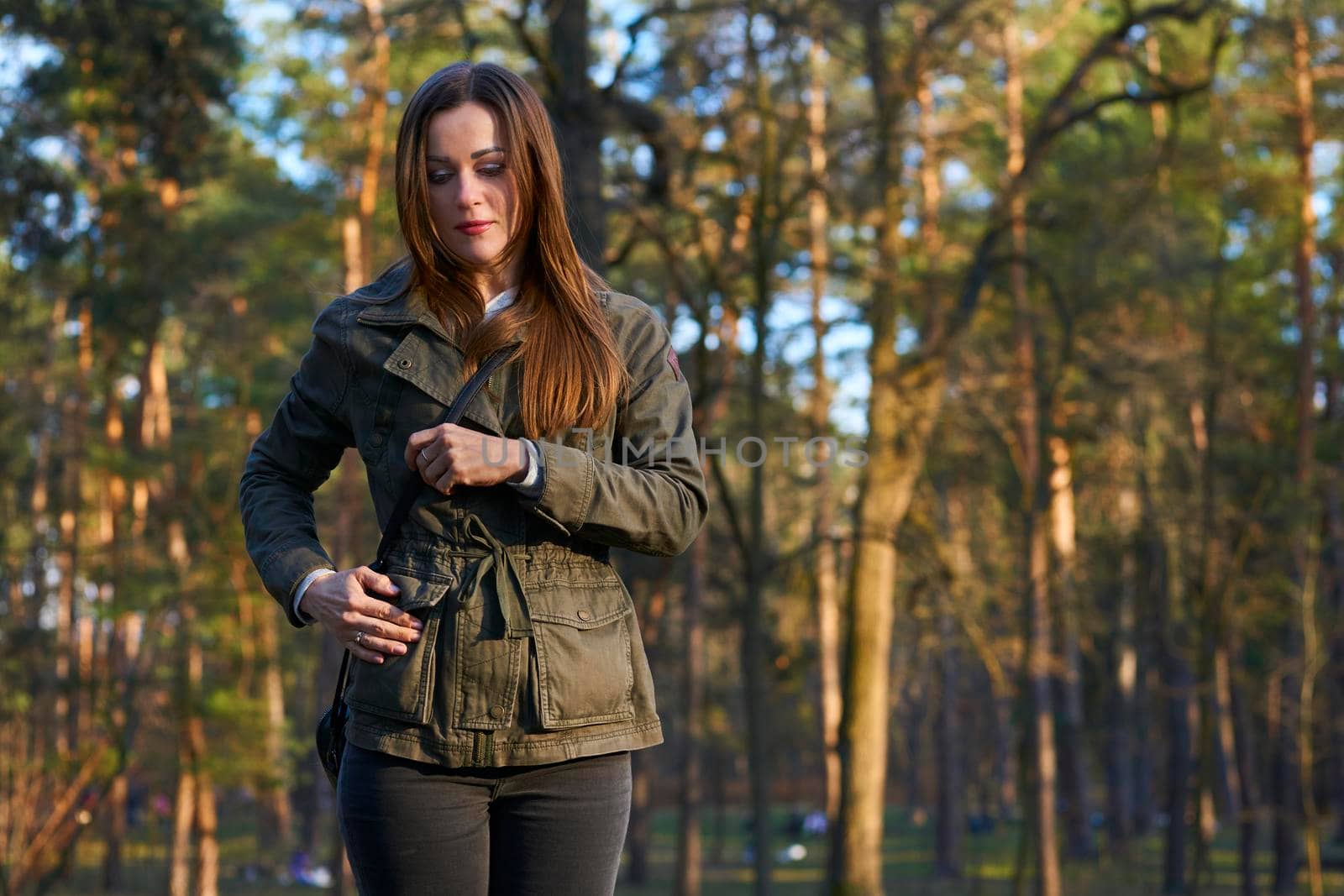 Pretty young woman in a green jacket in autumn park with pine by jovani68