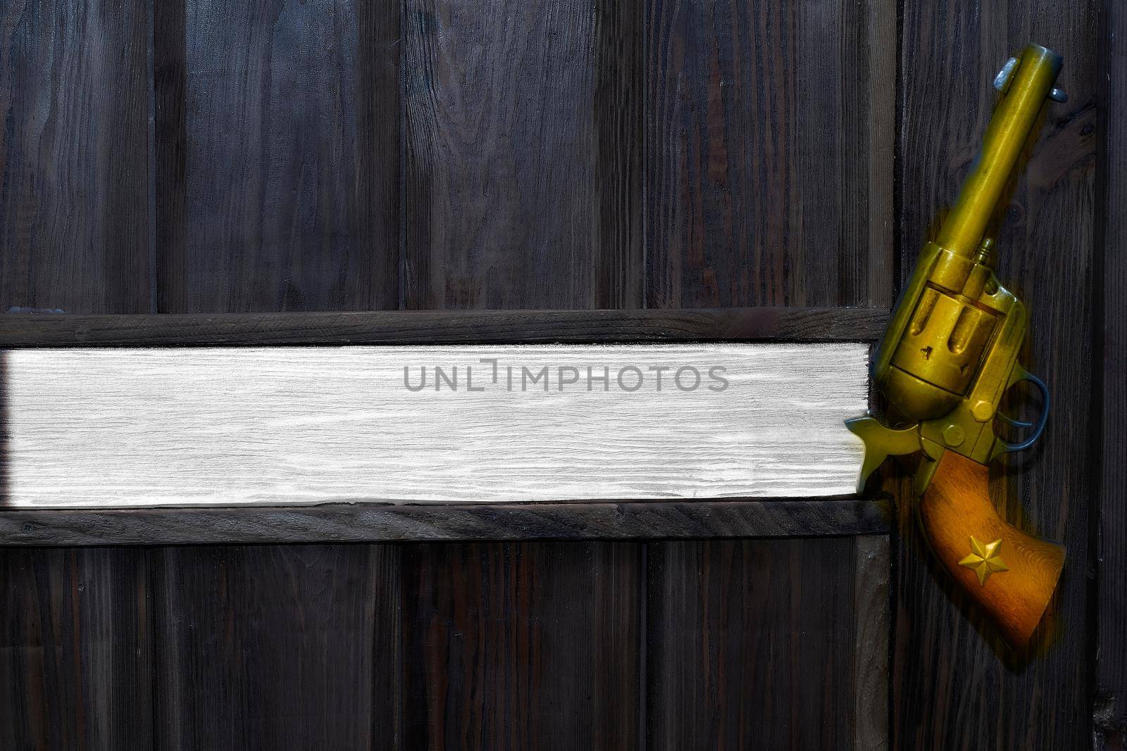 a pistol with revolving chambers enabling several shots to be fired without reloading. Cowboy gold gun colt revolver on a wooden black wall. Space for text. Boss's office