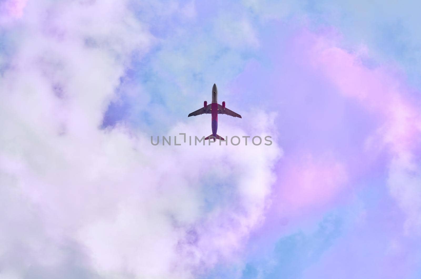 a flat surface on which a straight line joining any two points on it would wholly lie. Red passenger plane in blue sky with pink clouds
