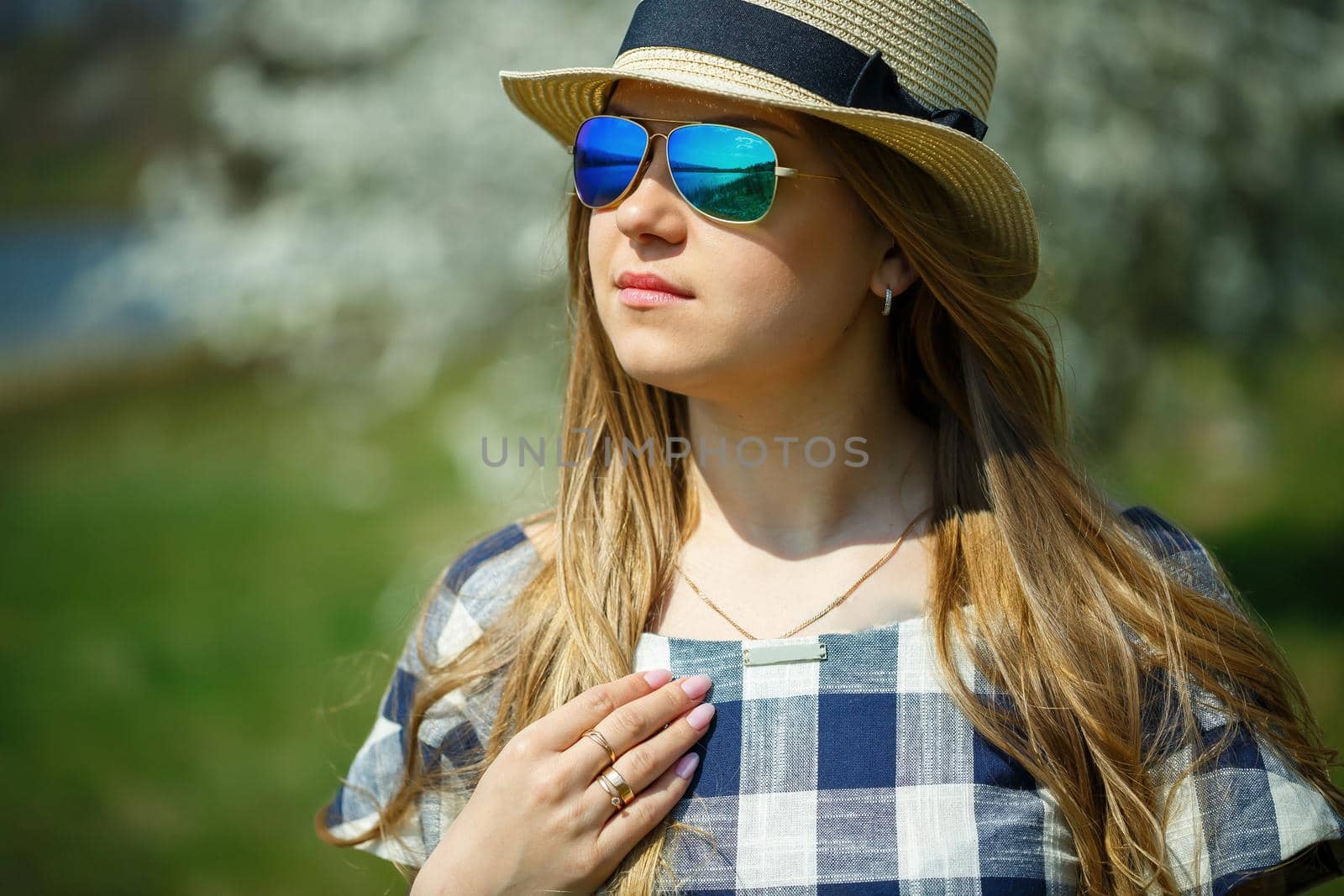beautiful girl in a dress walking in the spring forest where the trees bloom