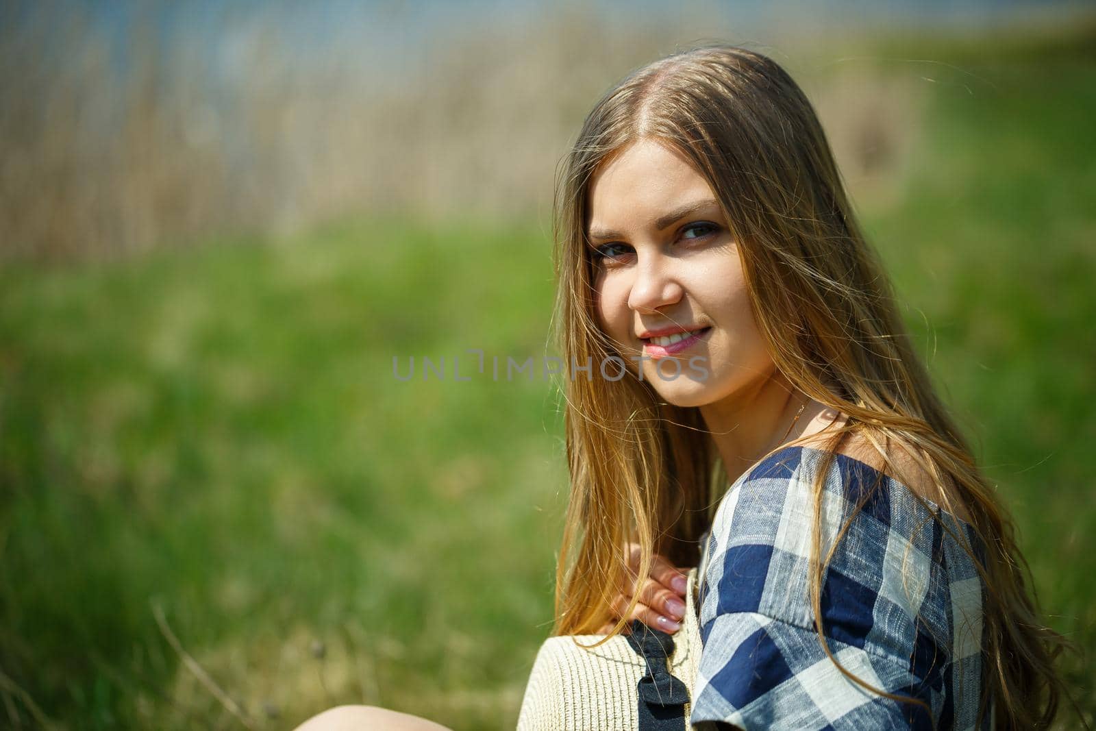 beautiful girl in a dress walking in the spring forest where the trees bloom