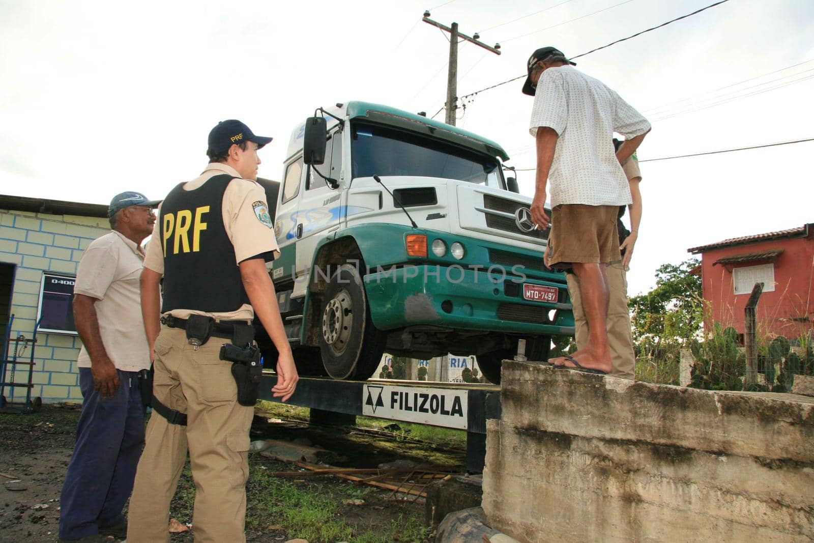 eunapolis, bahia / brazil - may 6, 2009: Federal Highway Police officer spotted during Operation on BR 101 Highway oversees overweight cargo vehicles.