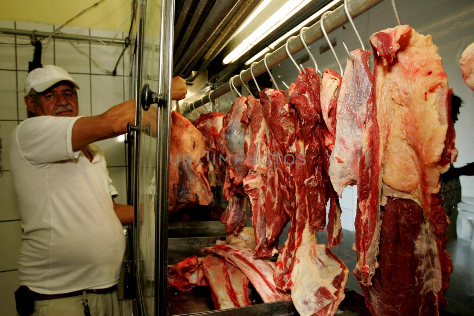 eunapolis, bahia / brazil - october 6, 2009: a butcher is seen holding a piece of bolvina meat on a market in the city of Eunapolis, in southern Bahia.