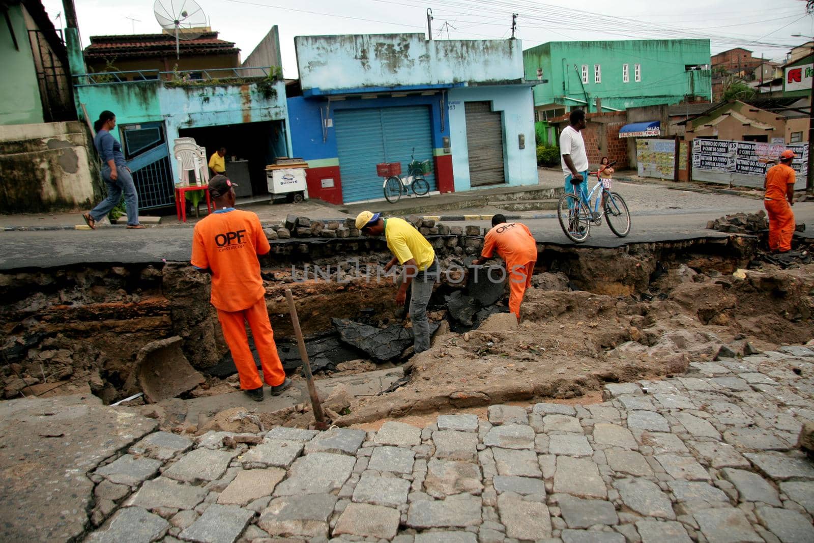 eunapolis, bahia / brazil - june 3, 2009: workers make repairs to rain-destroying street pavement in the city of Eunapolis, in southern Bahia.

