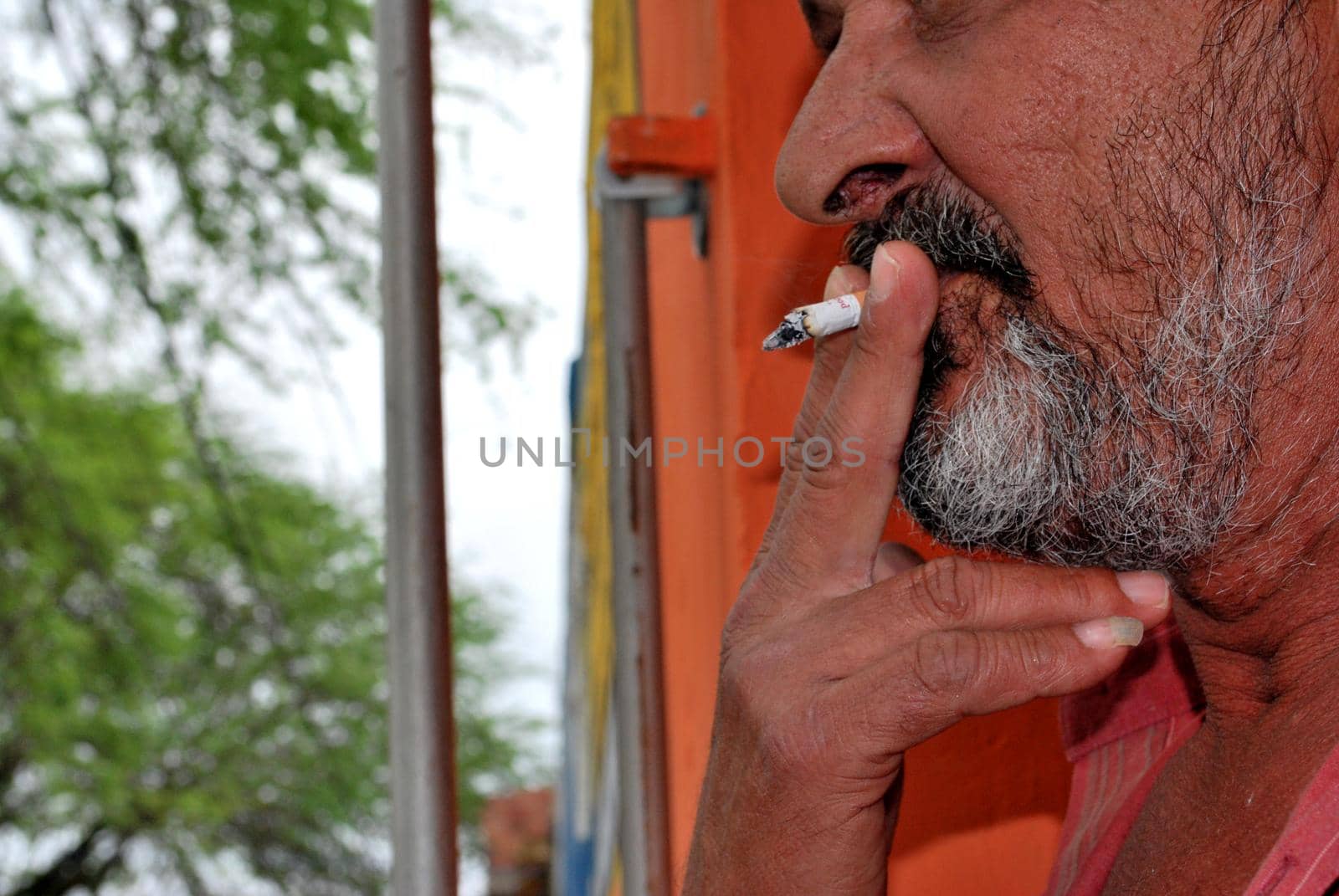 eunapolis, bahia / brazil - june 21, 2008: a person is seen smoking a cigarette in the city of Eunapolis.






