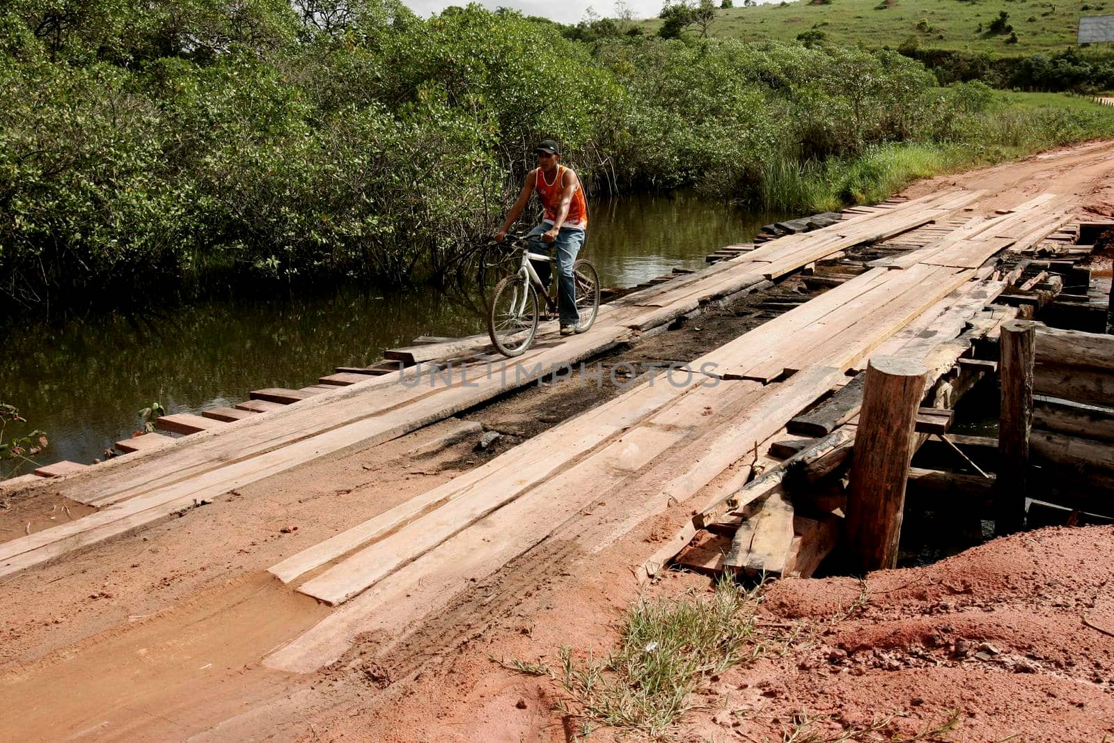 prado, bahia / brazil - july 7, 2009: vehicle is seen crossing wooden bridge over a dirt road in the rural area of the city of Prado, in southern Bahia.





