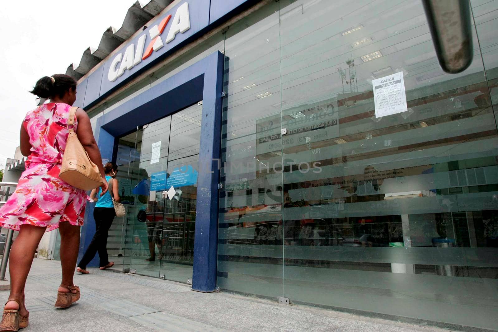 eunapolis, bahia / brazil - november 11, 2009: Customers are seen at the entrance of Banco Caixa Econômica Federal branch in the city of Eunapolis.