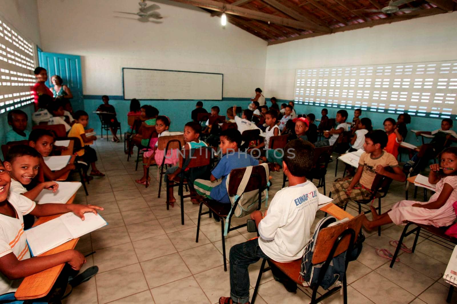 eunapolis, bahia / brazil - february 25, 2010: teacher and students are seen in the classroom of teacher helena Pereira de pinho municipal school in the city of eunapolis.
