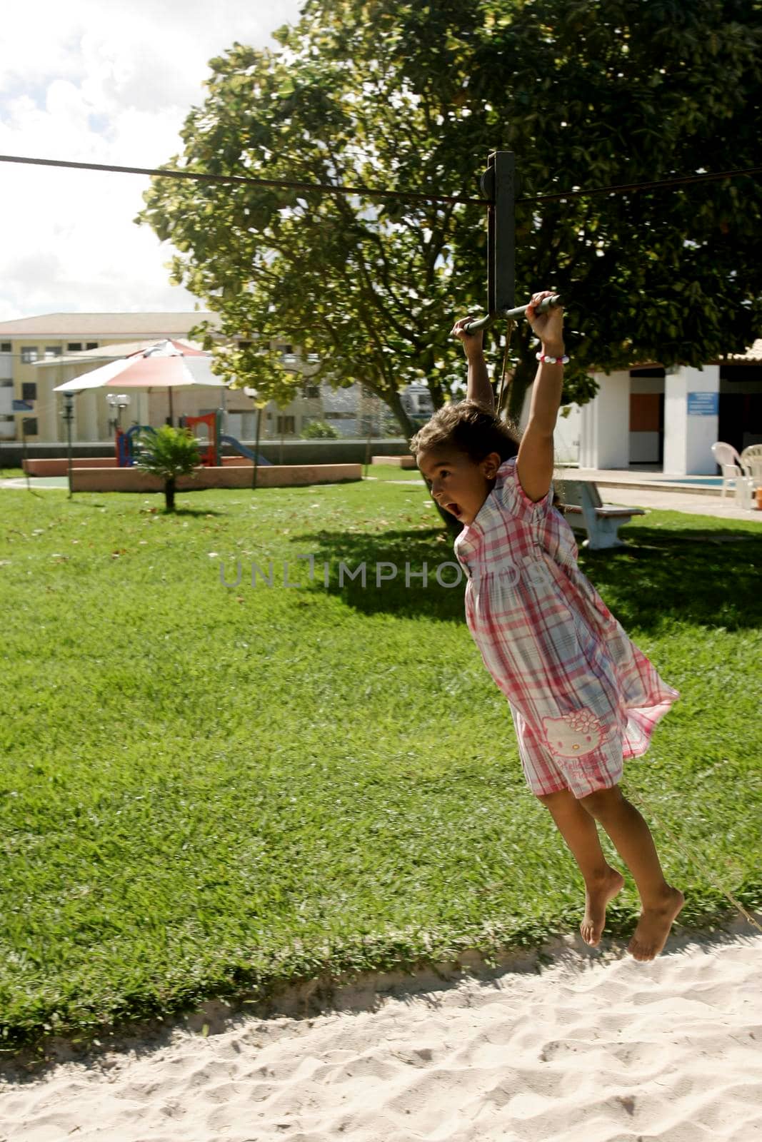 salvador, bahia / brazil - june 27, 2009: child is seen playing on zip lines in a condominium boat in the city of Salvador.