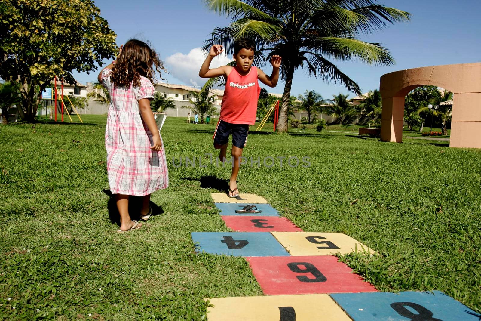 salvador, bahia / brazil - june 27, 2009: crinaça is seen playing with hopscotch game in a condominium boat in the city of Salvador.





