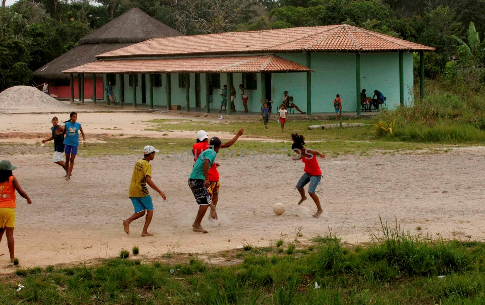 santa cruz cabralia, bahia / brazil - September 30, 2009: Indigenous children of the Pataxo ethnic group are seen playing soccer on land field area in Indian school in Coroa Vermelha village in Santa Cruz Cabralia city.

