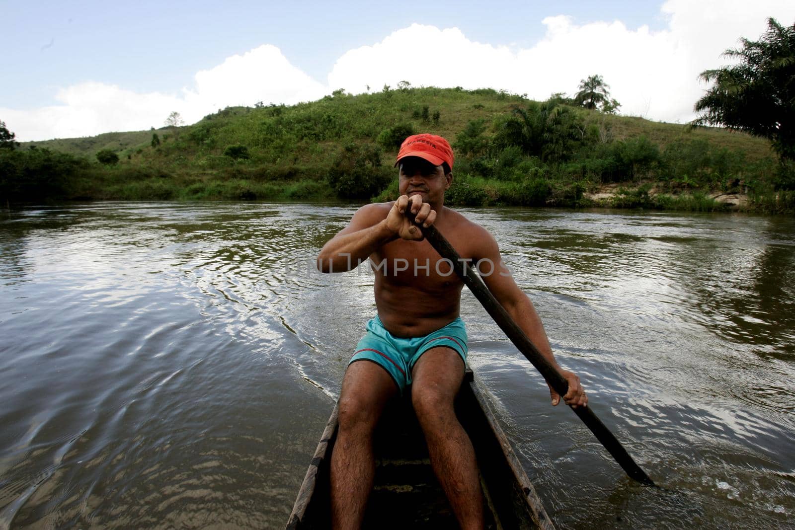 eunapolis, bahia / brazil - july 8, 2009: fisherman is seen in the waters of the Buranhem river in the city of Eunapolis, in southern Bahia.

