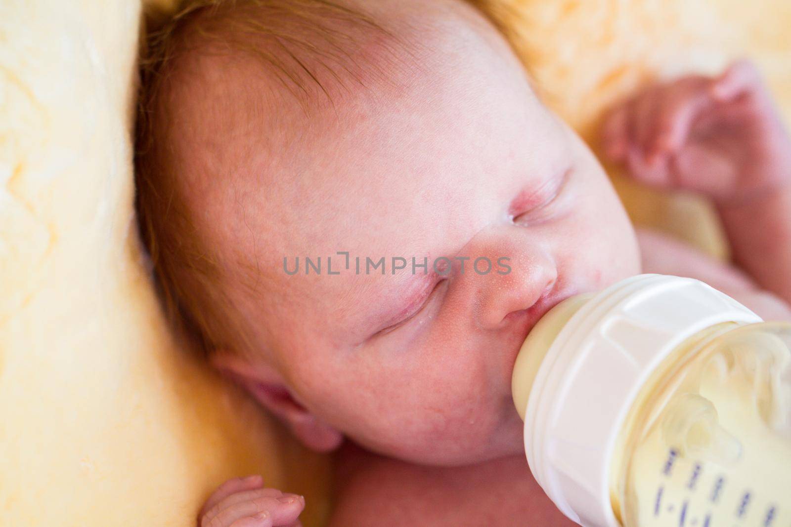Newborn baby girl at feeding time.