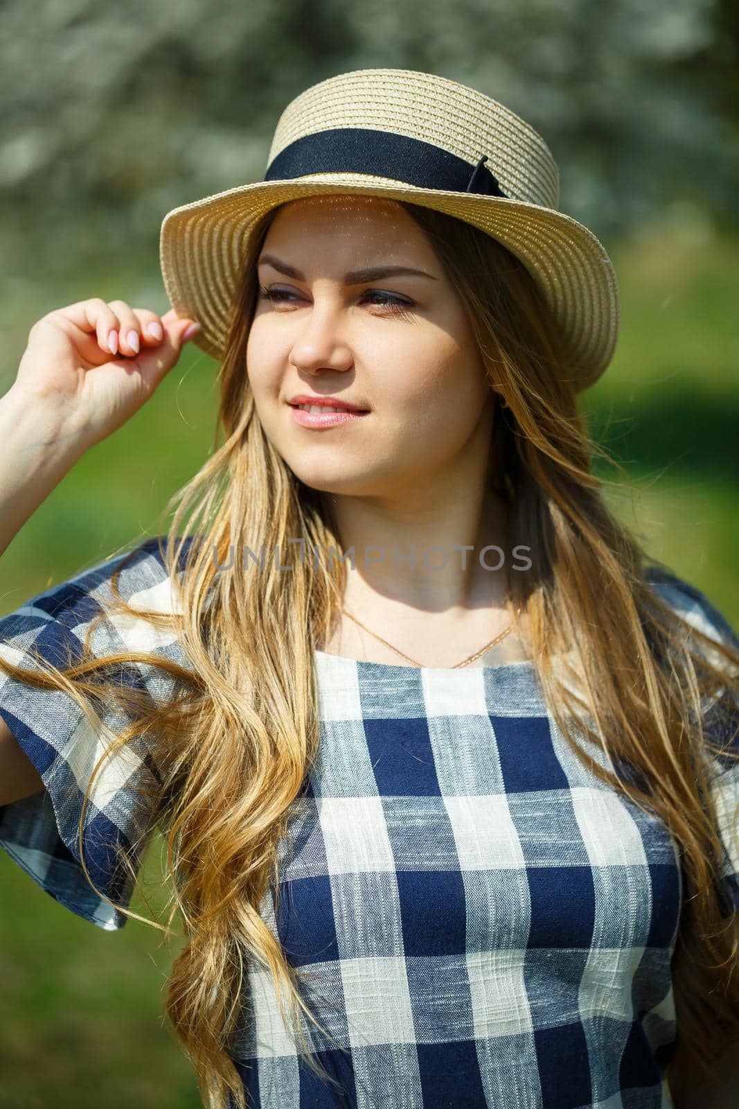 beautiful girl in a dress walking in the spring forest where the trees bloom