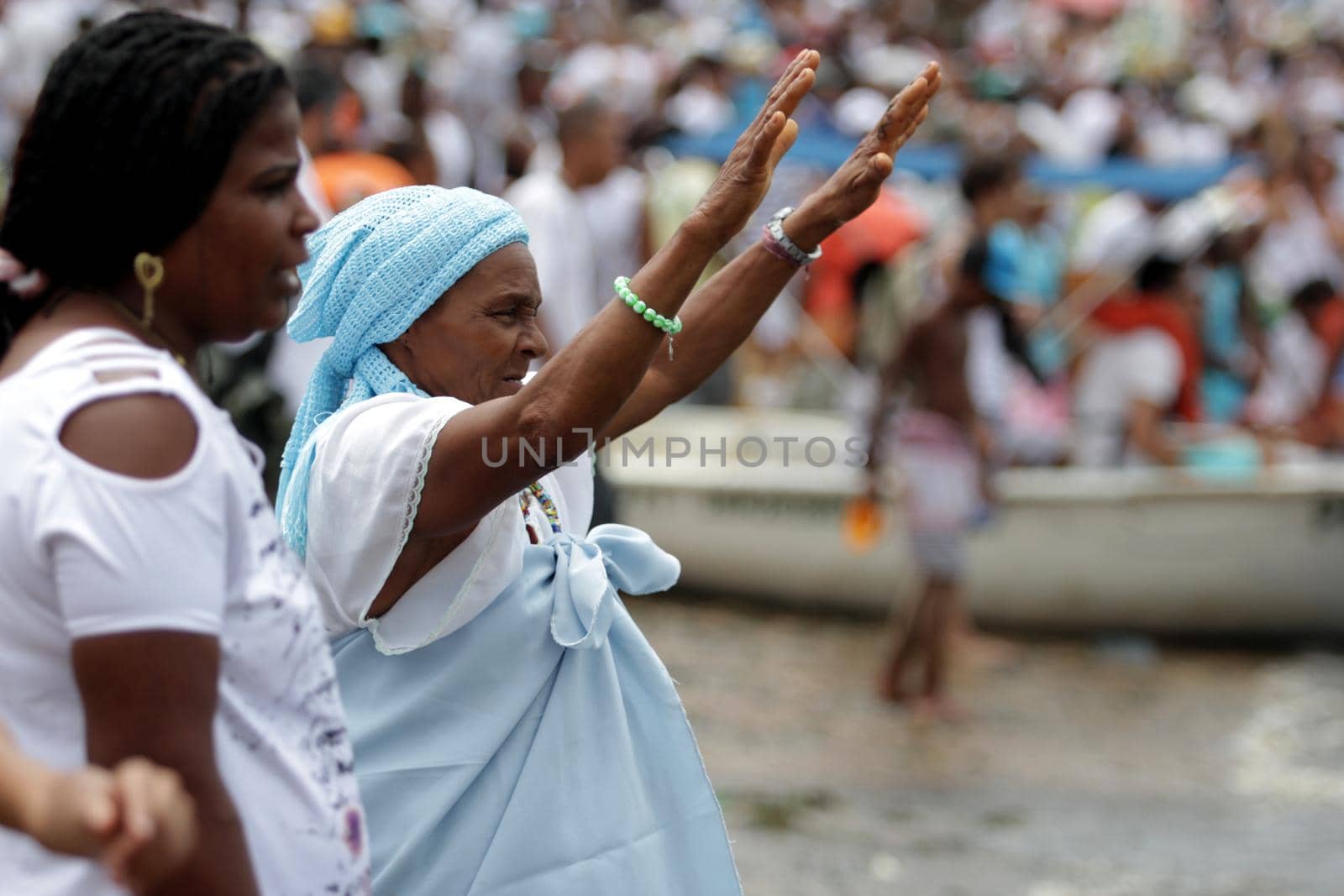 salvador, bahia / brazil - february 2, 2014: devotees and admirers of the orixa yemanja, a candomble entity, seen on the rio Vermelho beach, in the city of salvador, during a religious celebration.
