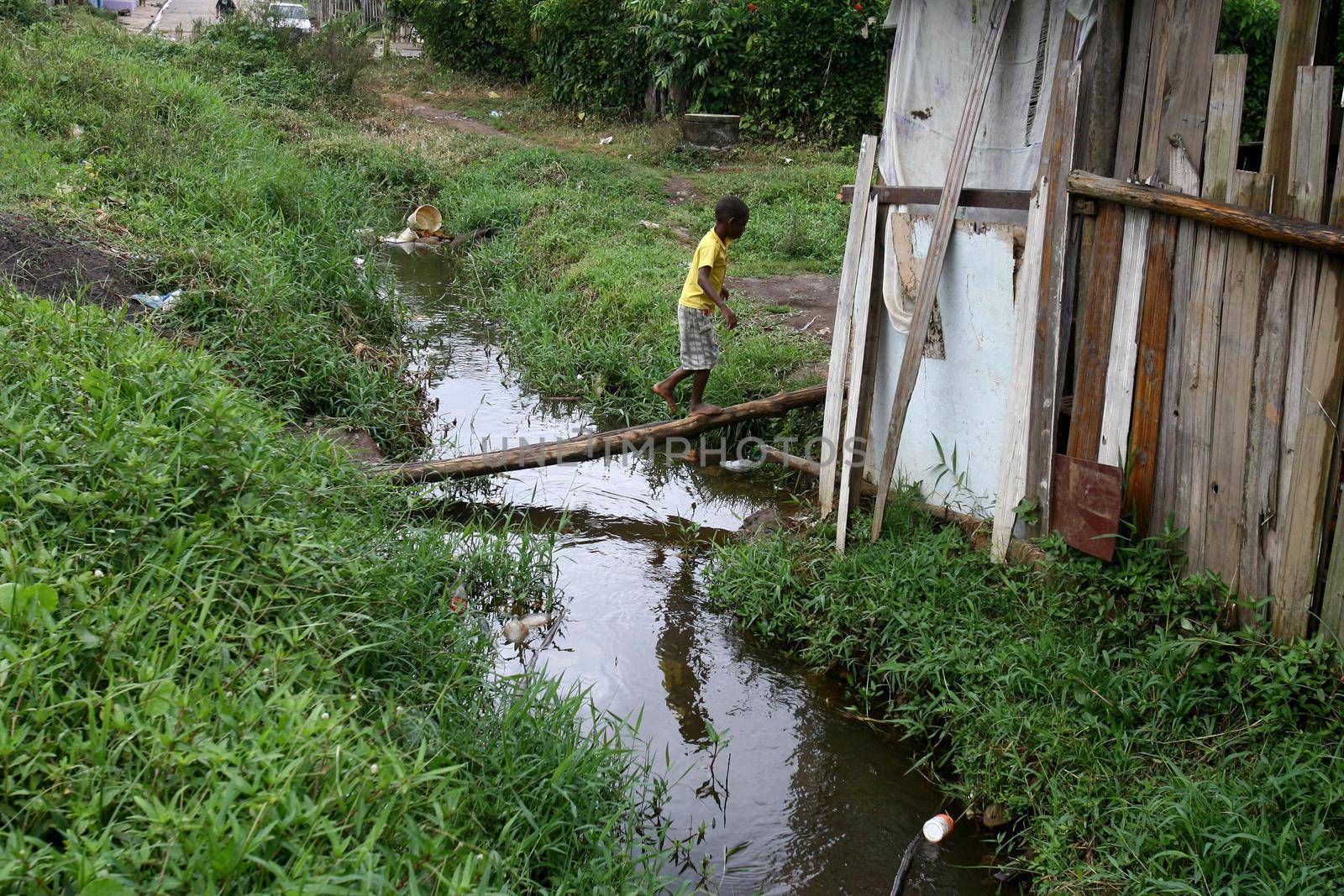 ilheus, bahia, brazil - march 5, 2012: water channel of a stream with polluted waters with domestic scum in the city of Ilheus.