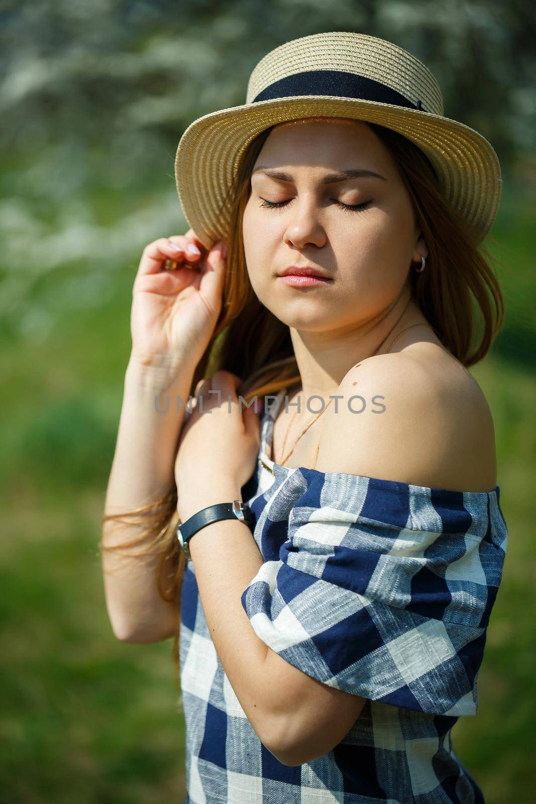 beautiful girl in a dress walking in the spring forest where the trees bloom